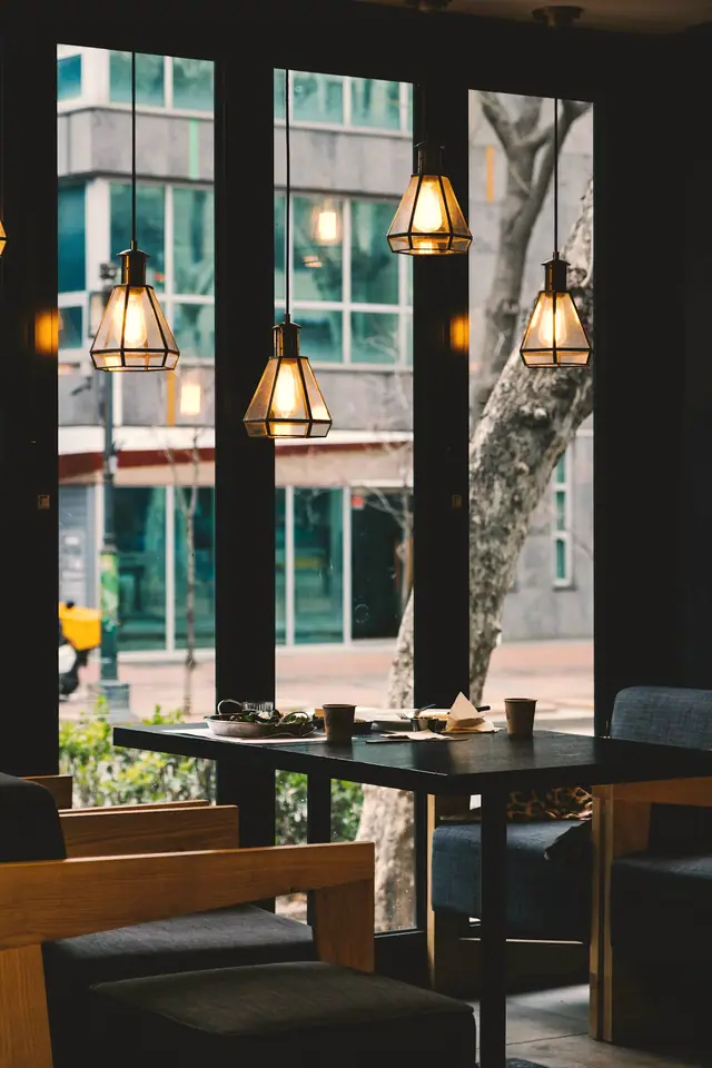 A café table beside tall windows