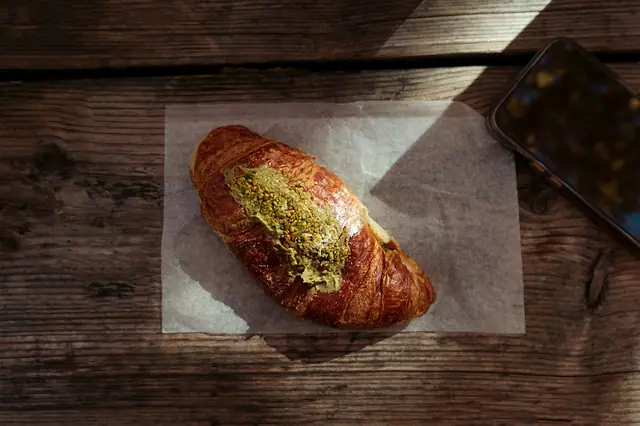 A croissant with a green za’atar topping